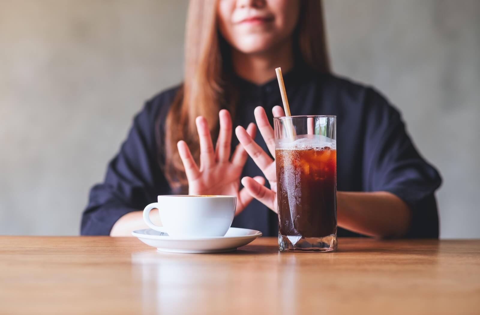 Somebody pushes away staining drinks like coffee and cola.